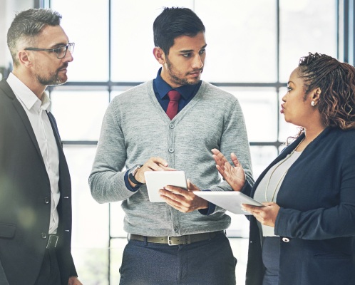 3 employees having a discussion around quote-to-cash automation