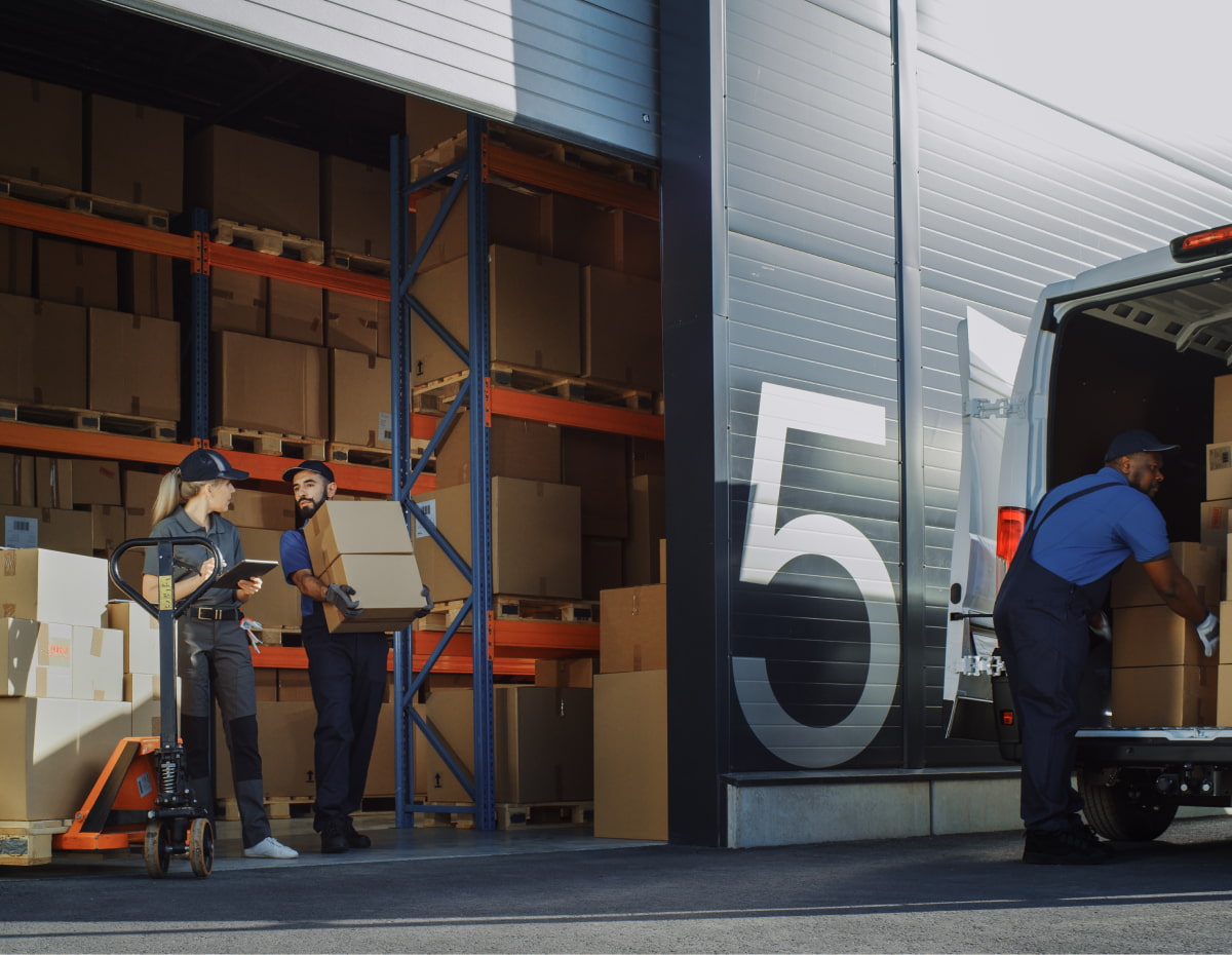 two supply chain workers loading up boxes