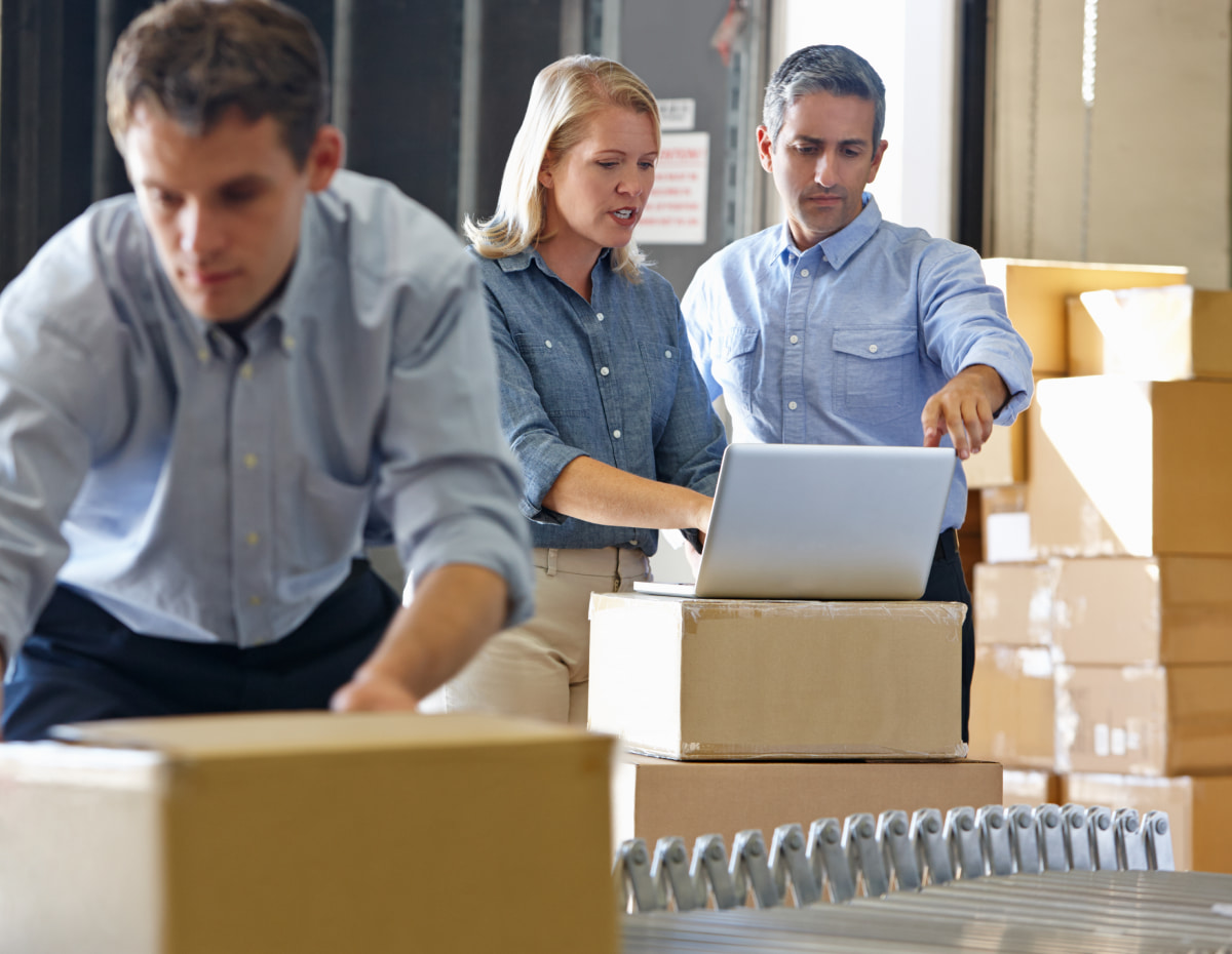 employees managing inventory in a retail warehouse