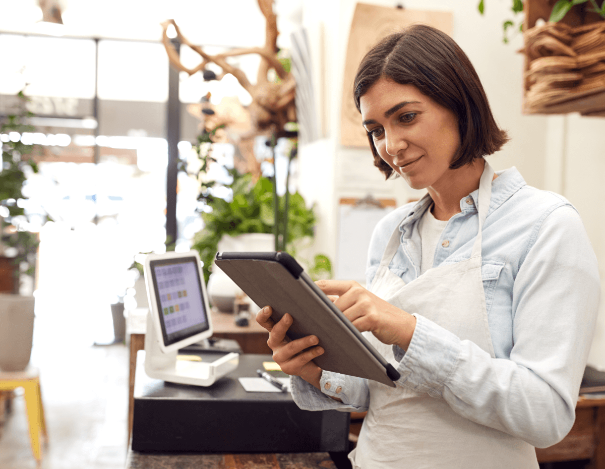 woman in a retail shop looking at a tablet