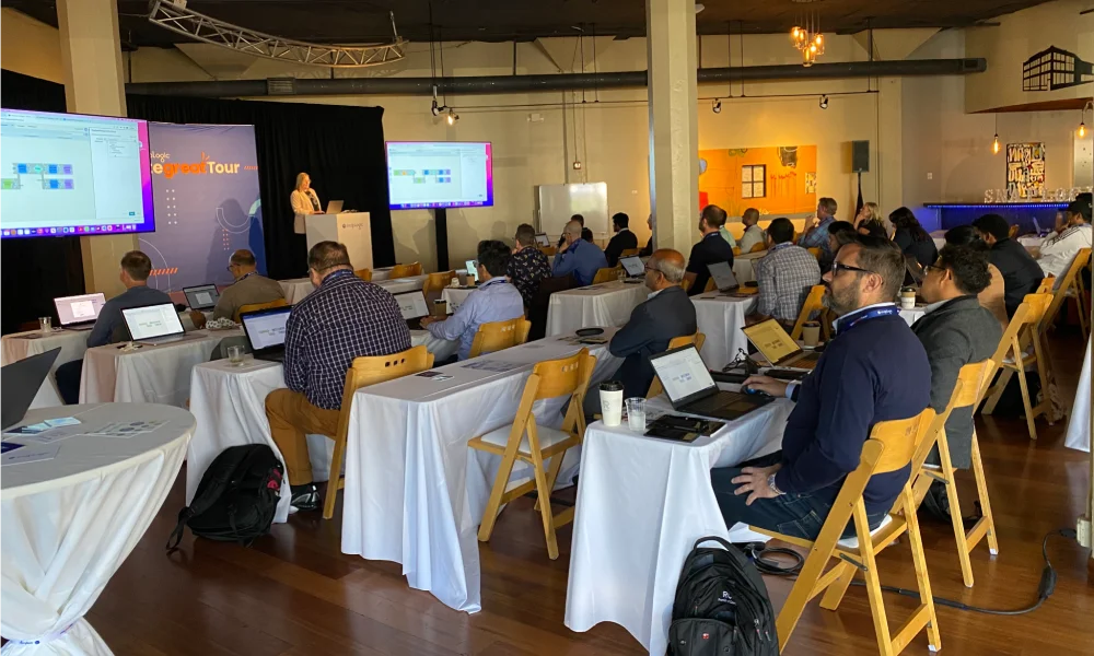 Attendees pack a room for the creating managed self-service at scale workshop to get hands-on experience and certification with the SnapLogic Designer, Patterns, AutoSync, and SnapGPT.